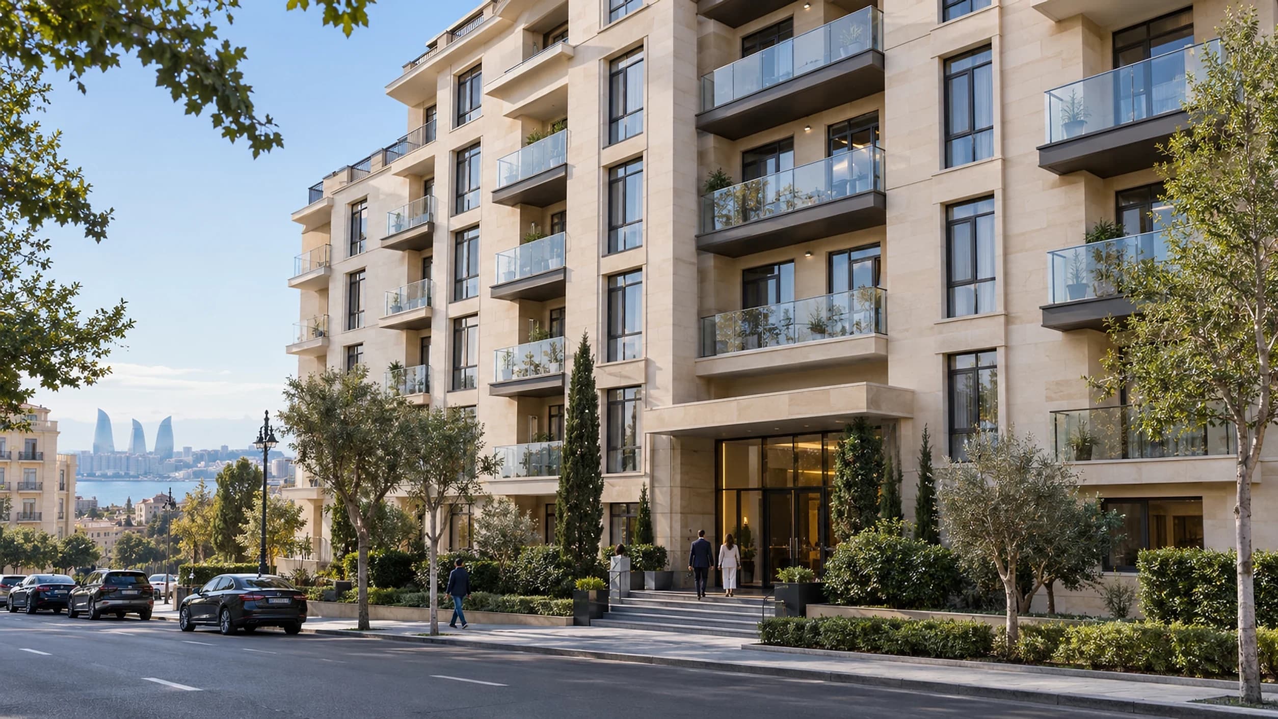 A modern stone-clad residential building with balconies on a tree-lined Baku street, the Flame Towers behind it